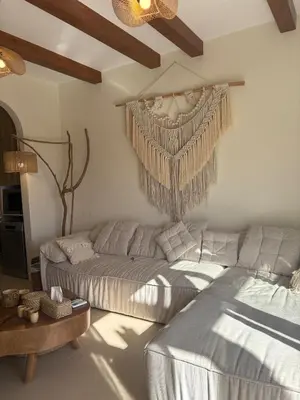 a living room with a couch and a bed at Boho El Gouna Shedwan 2BD Beach & Pool Access in Hurghada