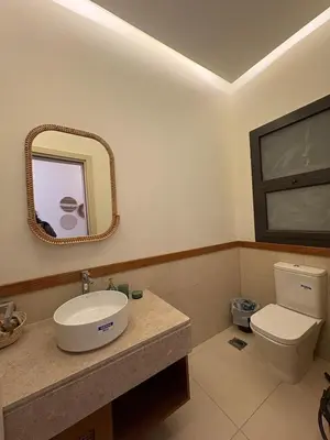 a bathroom with a sink and a toilet and a mirror at Boho El Gouna Shedwan 2BD Beach & Pool Access in Hurghada