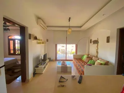 a living room with a couch and a table at El Gouna - Sabina - Lagoon Chalet - 2 bedrooms - Ground Floor in El Gouna