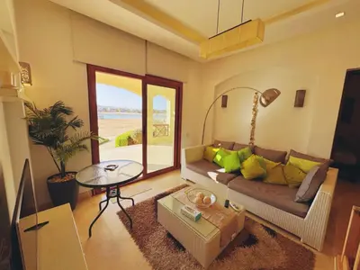 a living room with a couch and a table at El Gouna - Sabina - Lagoon Chalet - 2 bedrooms - Ground Floor in El Gouna