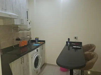 a kitchen with a sink and a washing machine at Casblanka beach in Hurghada
