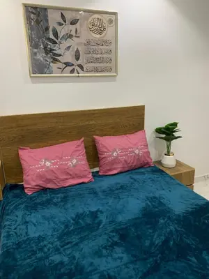 a bedroom with a bed with two pink pillows at Sea Light Arabia in Hurghada