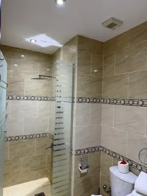 a bathroom with a shower with a toilet and a sink at Studio in gravity hotel & aquapark hurghada in Hurghada