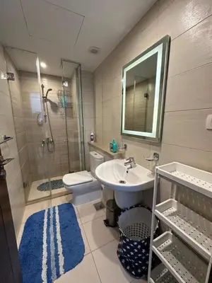 a bathroom with a sink and a shower and a toilet at Refined Two-Bedroom with Pool View Gcribs ElGouna in El Gouna