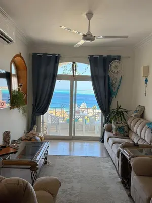 a living room with a couch and a view of the ocean at One bedroom apartment with stunning sea view in Hurghada