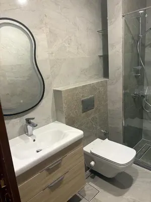a bathroom with a sink and a toilet and a mirror at TIBA GOLDEN Hurgada in Hurghada