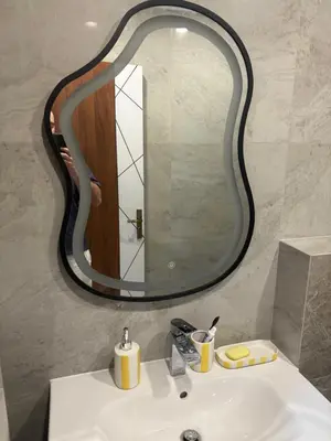 a bathroom sink with a large mirror above it at TIBA GOLDEN Hurgada in Hurghada