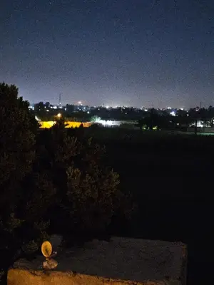 a view of a city at night with a fire hydrant at Hepton hotel