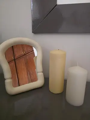 two candles sitting on a table next to a mirror at Westgolf Y62 in Hurghada