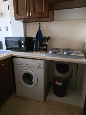 a kitchen with a washing machine under a counter at Westgolf Y62 in Hurghada