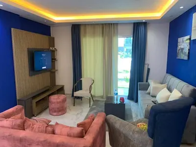 a living room with two couches and a tv at Elegant 3BR Luxury Suite - Fanadir Bay in Hurghada