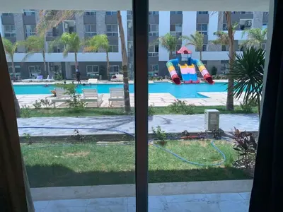 a view of a swimming pool from a window at Elegant 3BR Luxury Suite - Fanadir Bay in Hurghada