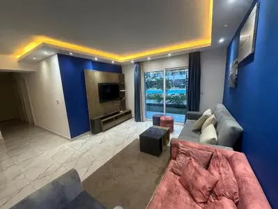 a living room with a couch and a tv at Elegant 3BR Luxury Suite - Fanadir Bay in Hurghada