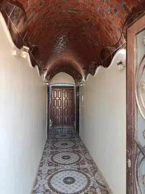 a hallway with a tile floor and a brick ceiling at Rooma ka Guest House in Aswan