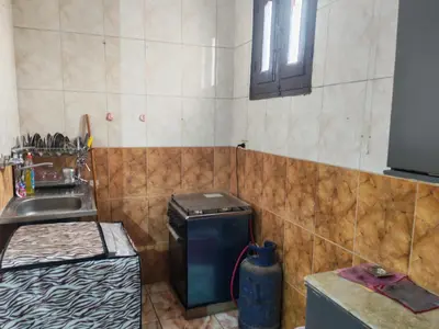 a small kitchen with a sink and a dishwasher at روف كناريا in Luxor
