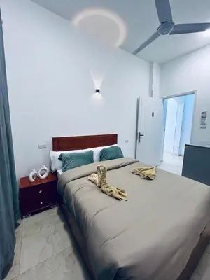 a bedroom with a large bed with bananas on it at Farah Hotel in Al Aqālitah