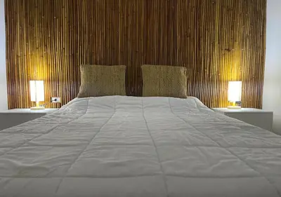 a bedroom with a large bed with two lamps at Luxury One-Bedroom Apartment Near El Gouna in Hurghada