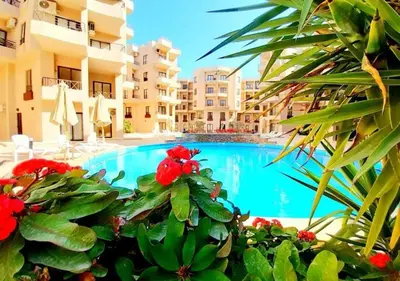 a swimming pool in front of some apartment buildings at Luxury One-Bedroom Apartment Near El Gouna in Hurghada