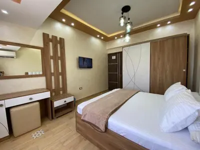 a bedroom with a large bed and a mirror at Star Beach 3BR in Hurghada