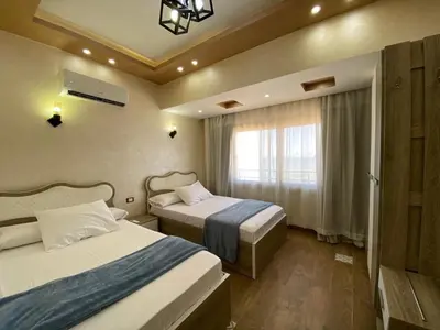 a hotel room with two beds and a window at Star Beach 3BR in Hurghada
