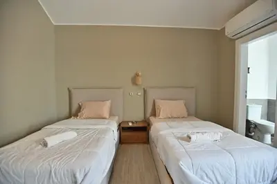 two beds sitting next to each other in a room at Bali - ELGOUNA - Premium Chalet with private pool in Hurghada