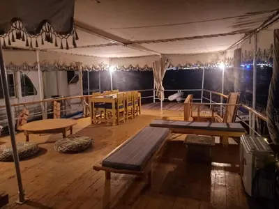 a deck of a boat with a table and chairs at Water Layla in Luxor