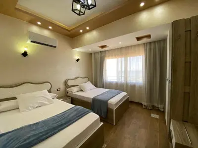 a hotel room with two beds and a window at Star Beach in Hurghada