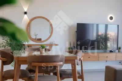 a dining room with a table and a mirror at Ladybird - Kamaran Pearl in Hurghada