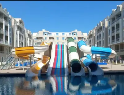 a group of water slides in a water park at Hub Hurghada Two Bedroom Luxury Apartment in Hurghada