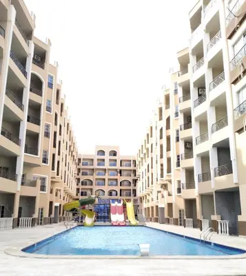 a swimming pool in the middle of a apartment complex at فندق جوليانا بيتش in Hurghada