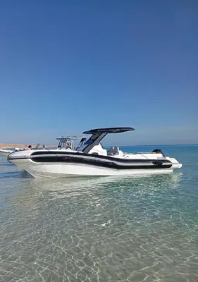 a speed boat sitting in the water on the beach at Speed Boat Tour Hurghada 4 Hours in Hurghada
