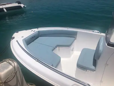 a white boat with a blue seat in the water at Speed Boat Tour Hurghada 4 Hours in Hurghada