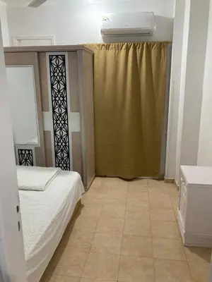 a small room with a bed and a window with at عماره المهندس in Hurghada