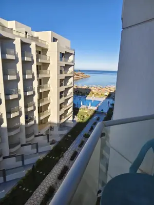 a view of the ocean from the balcony of a building at Holiday Seaview Home I Near Palacio Hotel I WIFI in Hurghada