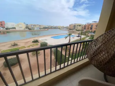 a balcony with a view of a body of water at Lovely 1 bd apartment with amazing view in Tawila in Hurghada
