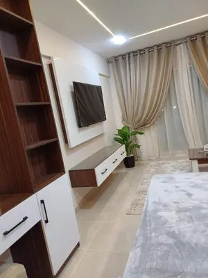 a bedroom with a bed and a tv on a wall at Tiba Golden Resort Hurghada in Hurghada