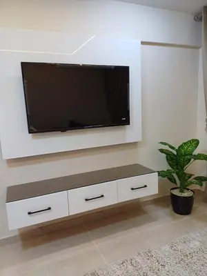 a living room with a flat screen tv on a wall at Tiba Golden Resort Hurghada in Hurghada