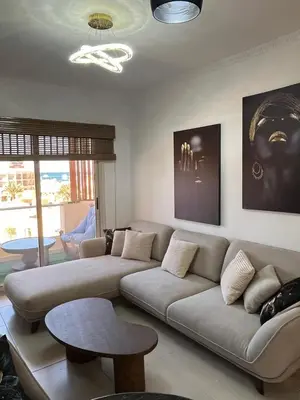 a living room with a couch and a table at Benashti Hurghada apartment in Hurghada