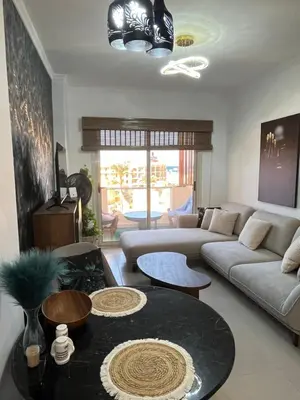 a living room with a couch and a table at Benashti Hurghada apartment in Hurghada