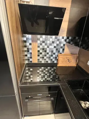 a kitchen with a black counter top with a drawer at Benashti Hurghada apartment in Hurghada