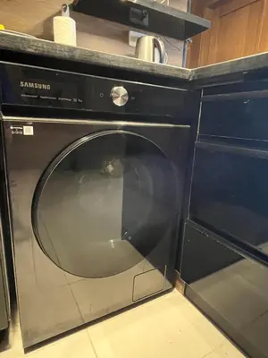 a black dishwasher in a kitchen with a counter at Benashti Hurghada apartment in Hurghada