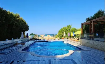 a large swimming pool with chairs and umbrellas at Balkan Beach Resort- Relaxing Beach Apartment in Hurghada