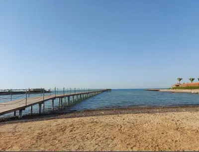 a pier stretches out into the water on a beach at Balkan Beach Resort- Relaxing Beach Apartment in Hurghada