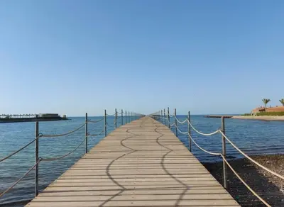 a wooden pier with ropes on the water at Balkan Beach Resort- Relaxing Beach Apartment in Hurghada