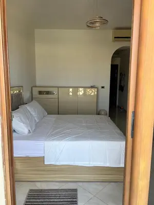 a bedroom with a large bed with white sheets at Appartement hurghada gravity beach in Hurghada