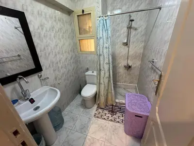 a bathroom with a shower and a toilet and a sink at 2 bedroom furnished apartment in Hurghada