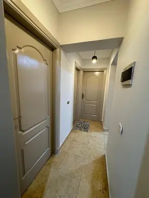 an empty hallway with a door and a tile floor at 2 bedroom furnished apartment in Hurghada
