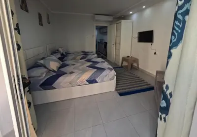 a bedroom with a bed and a television in it at Scandic Resort in Hurghada