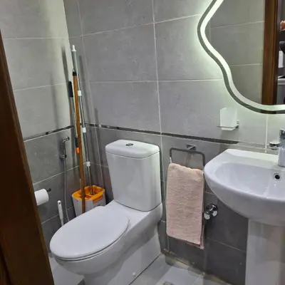 a bathroom with a white toilet and a sink at Luxury Apartment Pool&Private Beach in Hurghada