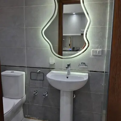 a bathroom with a sink and a mirror and a toilet at Luxury Apartment Pool&Private Beach in Hurghada